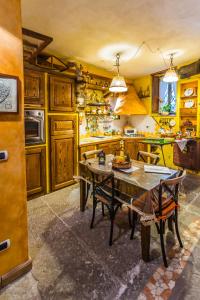 a kitchen with wooden cabinets and a table and chairs at L'Antico Loco Commodo in Viterbo