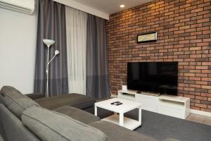 a living room with a brick wall at Miracle Apartment Hotel in Baku