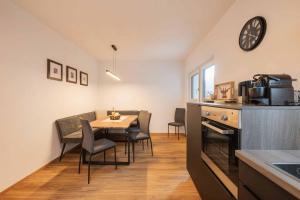a kitchen and dining room with a table and chairs at Haus Bacher in Fulpmes