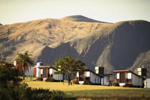 a row of houses in front of a mountain at Pousada Oká Canastra in São Roque de Minas