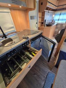 an interior of an rv kitchen with a counter at Rosenzauber Caravan in Münchberg
