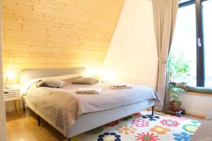 a bedroom with a bed and a large window at Hanguloft - The cozy cabin by the lake in Hangul