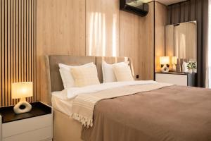 a bedroom with a large bed with white pillows at Luxe Apartment 18-th floor and sky view in Tashkent City NRG U-Tower in Tashkent