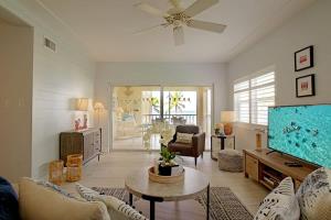 a living room with a large flat screen tv at Plantation Village #20 Condo in Seven Mile Beach