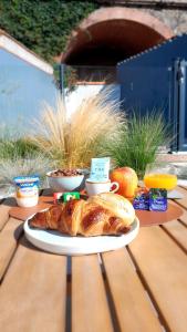 a table with a loaf of bread on a plate at Hôtel Le Ribéral in Cerbère +16 photos