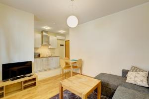 a living room with a couch and a table at Hommiku 8a Apartment in Pärnu