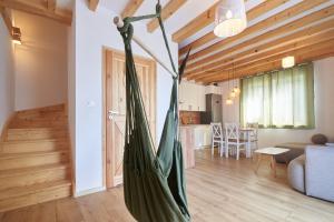 a hammock in the living room of a house at Zielony Dom in Marczyce