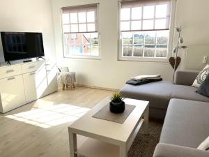 a living room with a couch and a table at Leuchtturm in Juist