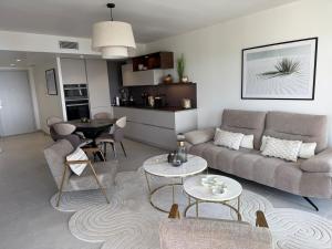 a living room with a couch and a table at 2-bedroom apartment with breathtaking ocean view in Éze
