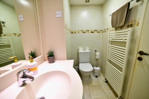 a bathroom with a white toilet and a sink at Laouri Traditional 2-Bedroom in Kalopanayiotis in Kalopanayiotis +12 photos
