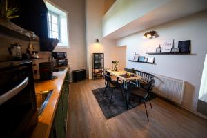 a kitchen with a table and chairs in a room at EifelturmSuite in Utscheid
