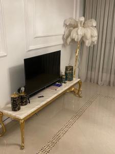 a television sitting on a table in a living room at ORAN MOBILART 4 PIECES MODERN apartement in Oran