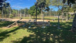 a park with a playground with a swing set at CHACARA Realiza in Aragarças