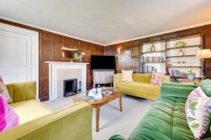 a living room with a couch and a fireplace at 2 The Old Vicarage in Wangford