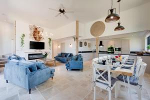a living room with a blue couch and a table at The Mill in Briston