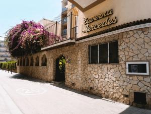 a building with a sign on the side of it at Vintage Hotel Mercedes in Lloret de Mar