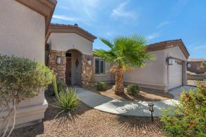 a house with a palm tree in front of a driveway at Havasu Duke Pool Spa Basketball Central in Lake Havasu City