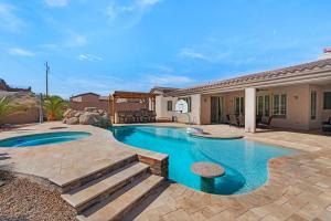 a swimming pool with a patio and a house at Havasu Duke Pool Spa Basketball Central in Lake Havasu City