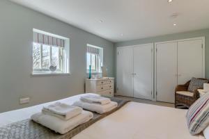 a bedroom with a bed with towels on it at West Barn Cottage in Aldringham