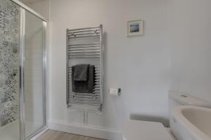 a bathroom with a shower and a toilet and a sink at The Old Hall Farm House in Reydon +20 photos