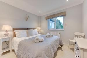 a bedroom with a bed with towels on it at Dakings in Halesworth