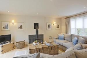 a living room with a couch and a fireplace at Velsheda in Thorpeness