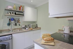 a kitchen with a counter top with a loaf of bread at Stones Throw in Southwold