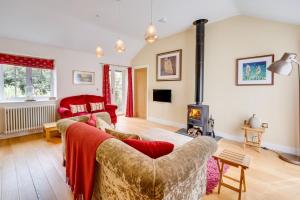 a living room with a couch and a fireplace at Woodland Lodge in Wilby