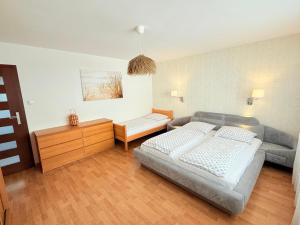 a living room with a bed and a couch at Albatros PRZY PLAŻY in Władysławowo