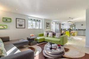 a living room with a couch and a table at East Barn Cottage in Aldringham