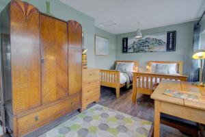 a bedroom with a large wooden cabinet and a bed at Hideout in Felixstowe