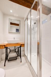 a bathroom with a sink and a shower at London Cottage in Halesworth