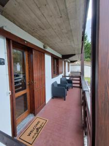 a corridor of a building with chairs and tables at Il Rifugio dell'Artista in Folgarida +55 photos