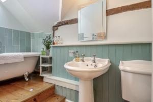 a bathroom with a sink and a bath tub and a sink at Alde Cottage in Friston +19 photos