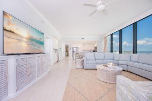 a living room with a large flat screen tv at Phoenix Gulf Shores II 605 condo in Gulf Shores