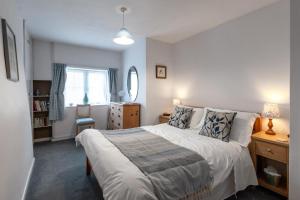 a bedroom with a large bed and a window at 3 Church Street in Reepham