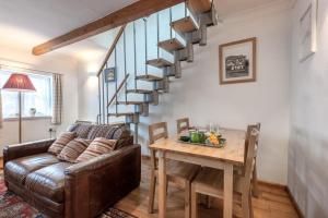 a living room with a couch and a table at 3 Church Street in Reepham