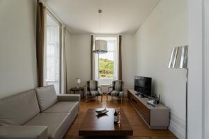 una sala de estar con un sofá y una mesa en Casa de Cambres - by RowdHouses, en Lamego