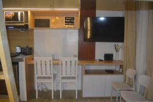 eine kleine Küche mit einem kleinen Tisch und Stühlen in der Unterkunft Adrian's Place at La Bella Tagaytay in Galicias