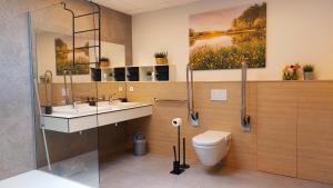 a bathroom with a toilet and a sink at Vakantiewoning De Schuur Tienen in Tienen +19 photos