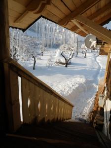 a winter view of a porch with snow on the ground at Salamandra Village in Kozevo