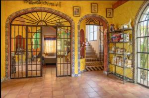 a room with two entry doors in a house at Casa de Hospedaje Jardin del Tuito in El Tuito
