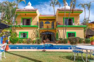 a house with a pool in front of it at Casa de Hospedaje Jardin del Tuito in El Tuito