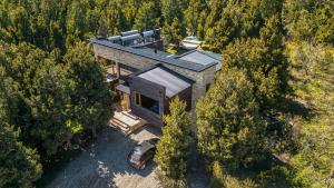 an aerial view of a house in the woods at Stunning 4-Bedroom House Large Garden and Pool H61 by Apartments Bariloche in San Carlos de Bariloche