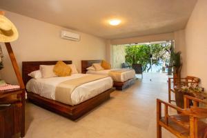 a bedroom with two beds and a balcony at Corrales Bay Resort in Corrales