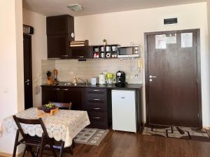 a kitchen with a table and a small kitchen with a sink at Ski Lift Studio 531 in Bansko