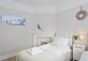 En eller flere senge i et værelse på Southwold Gallery Apartment