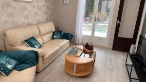 a living room with a couch and a coffee table at La Parenthèse in Longchaumois