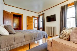 a bedroom with a bed and a couch at Great for Travel Nurses, Remote Workers! MPLS Home in Minneapolis
