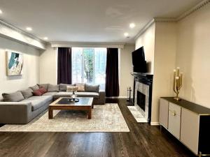 a living room with a couch and a table at NEW! Spacious Art Deco Modern 5 BD/3BA Condo in Chicago